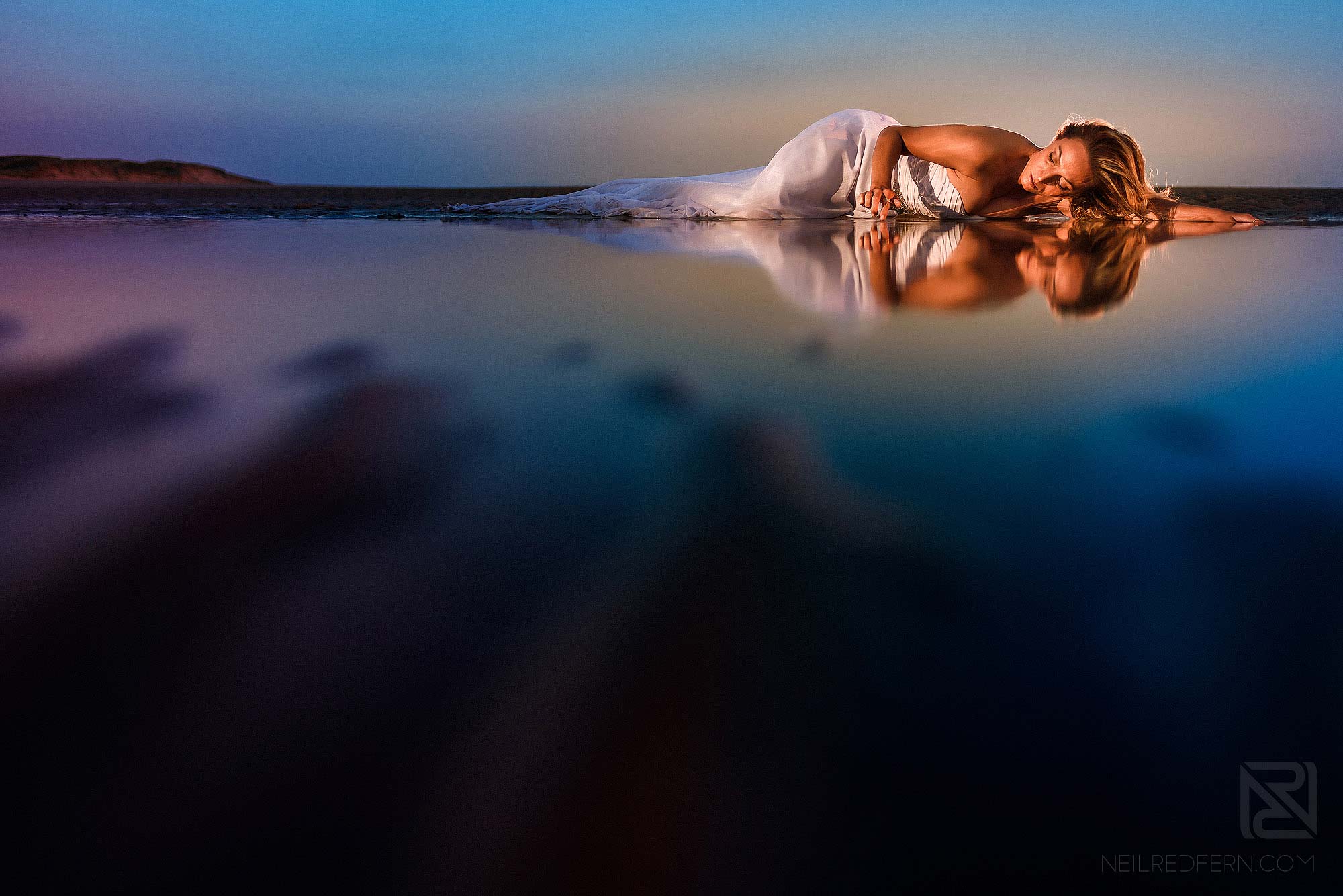 bride lying down on the beach
