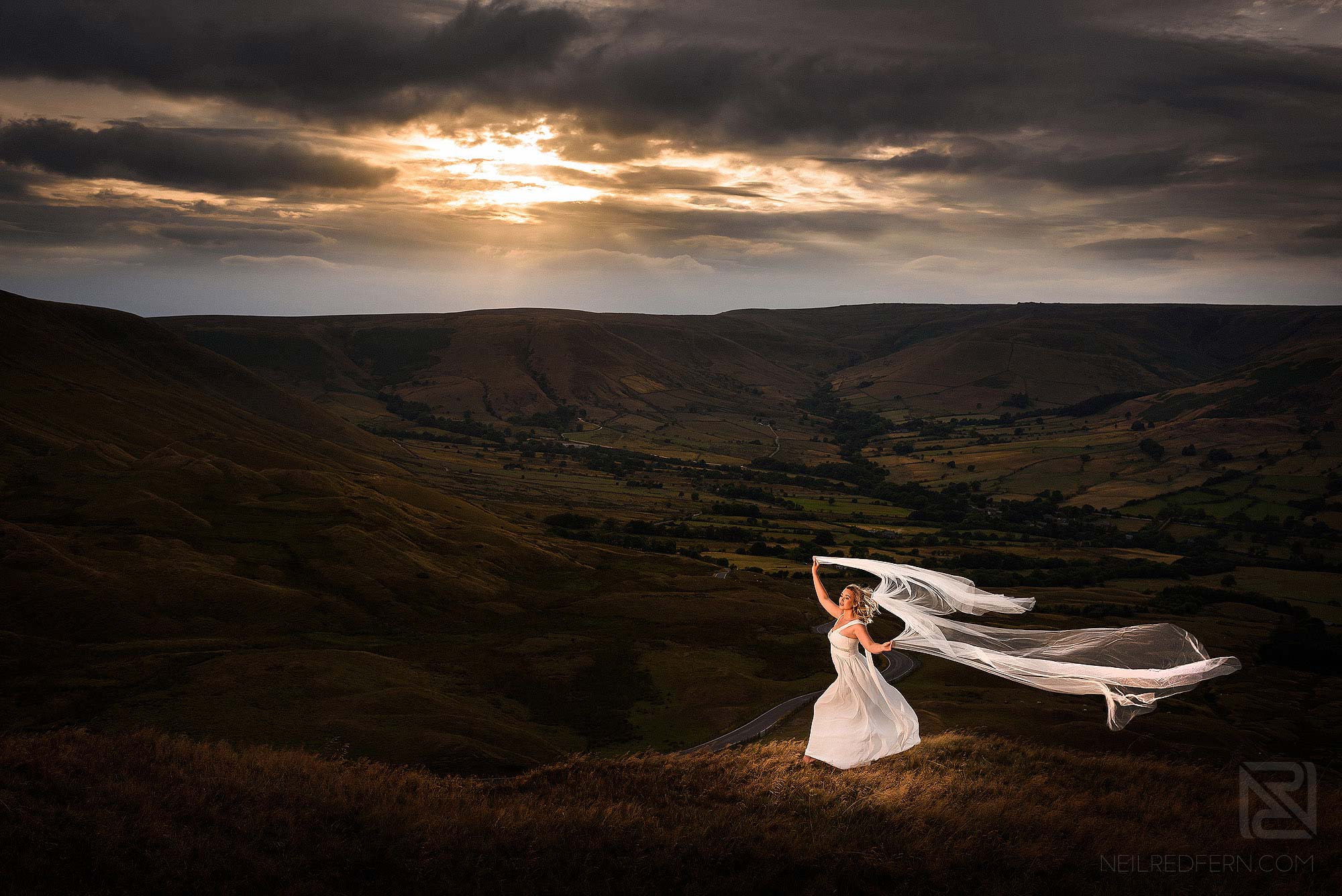 bride with long veil at Mam Tor in the Peak District