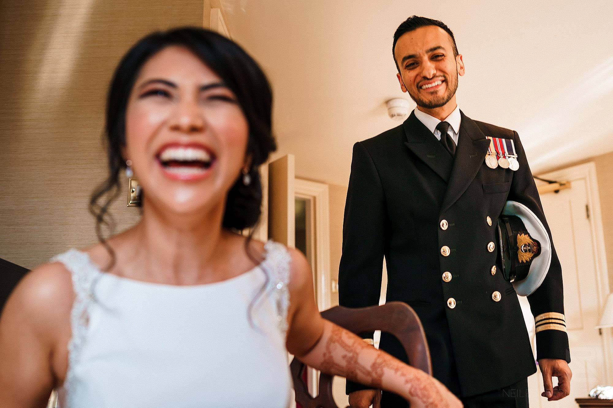 Indian bride and groom laughing 