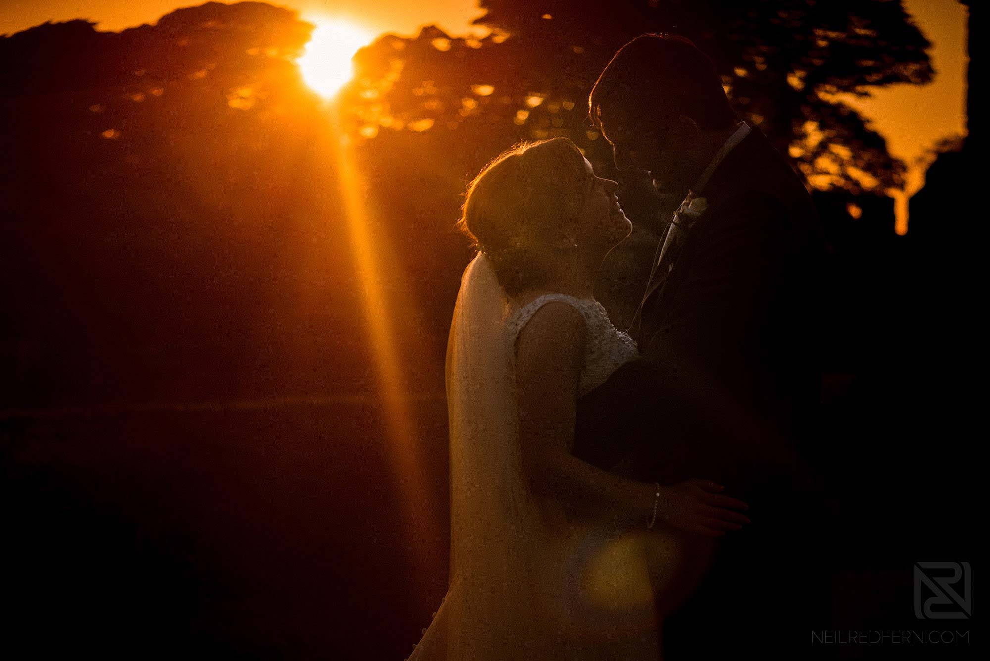 sunset portrait of bride and groom at Hoghton Tower