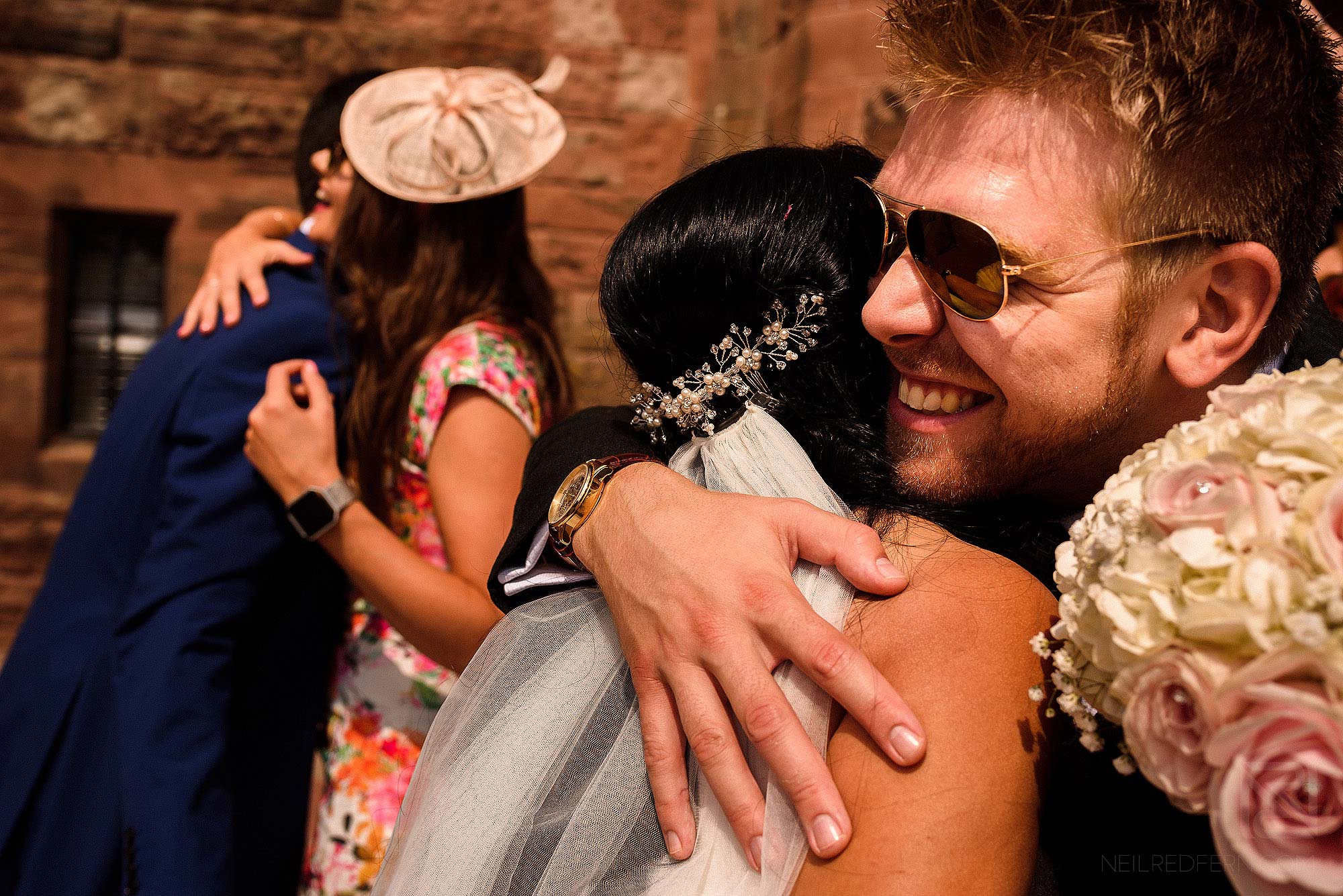 wedding guests congratulating bride and groom