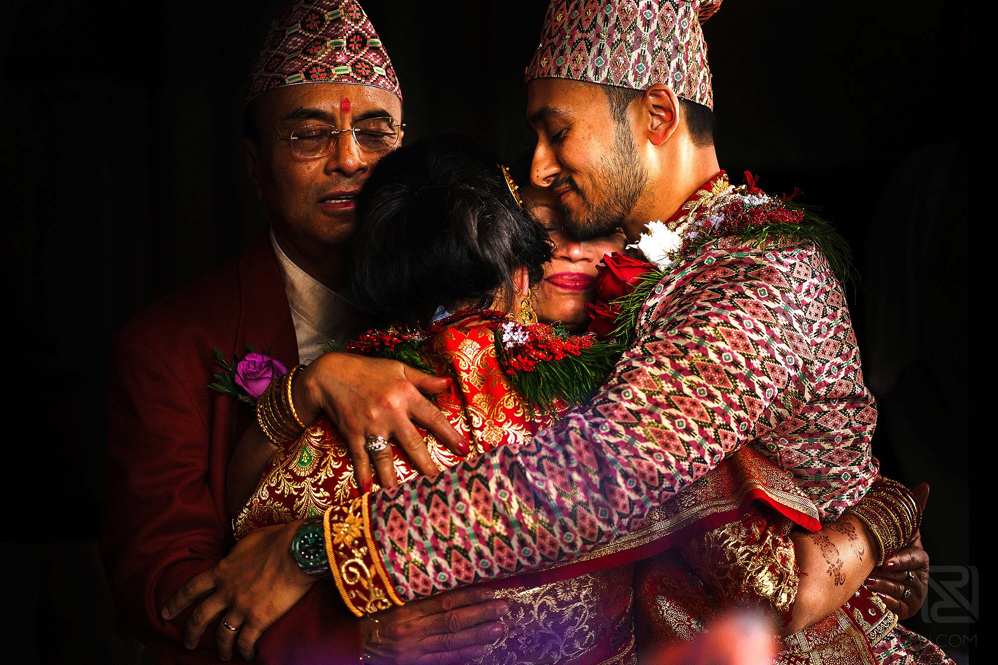 family hugging during Indian wedding ceremony