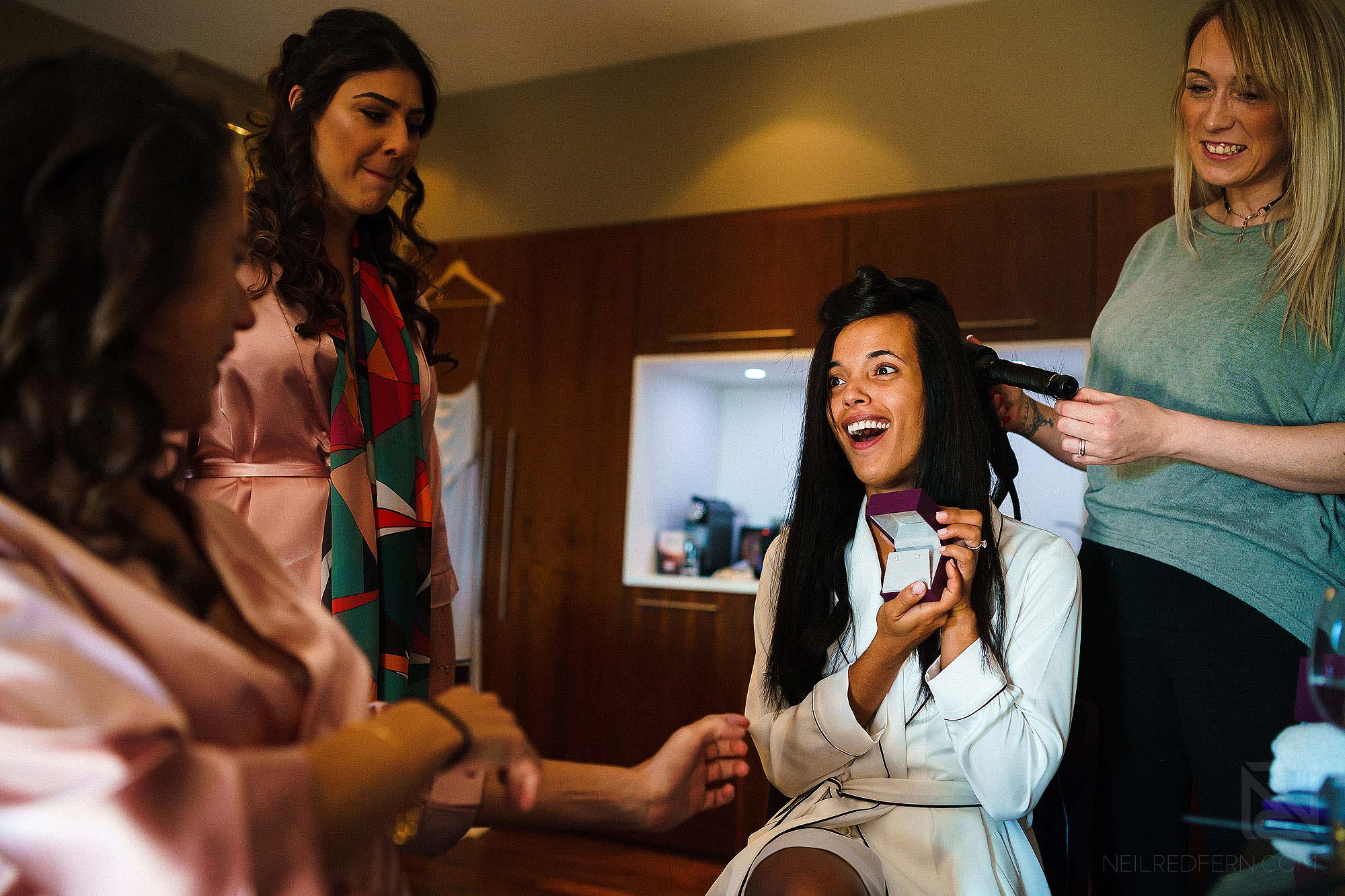bride opening present from groom on morning of wedding