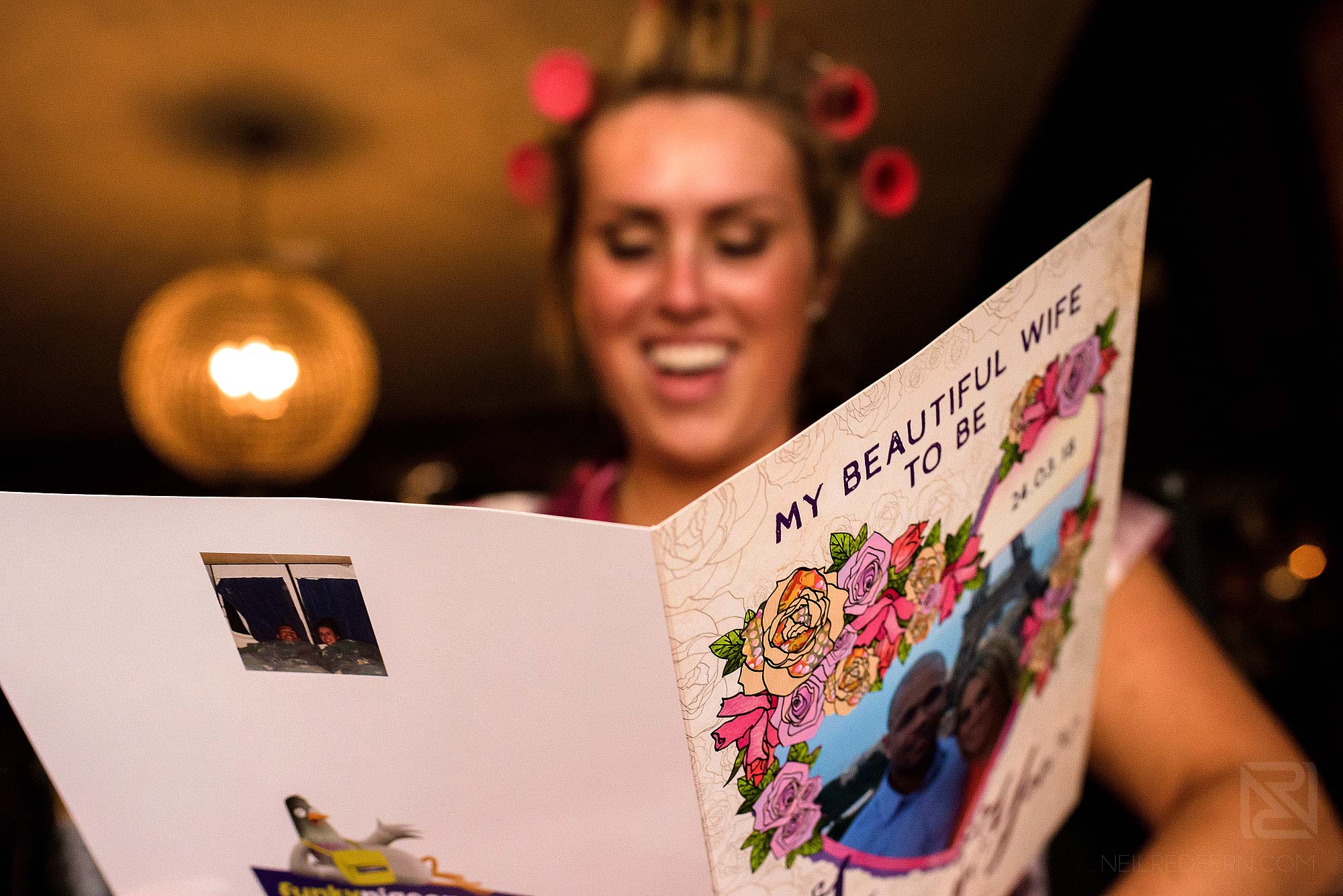 bride reading card from groom on morning of wedding