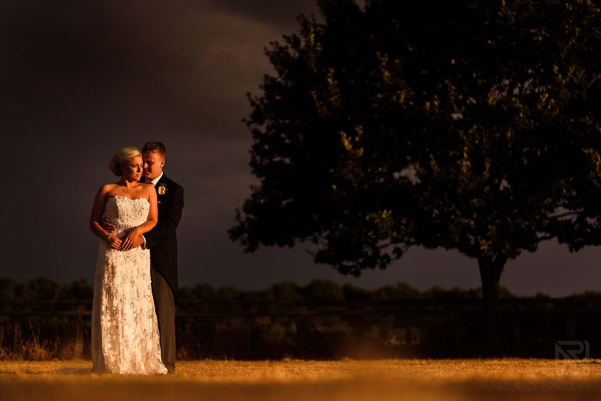 portrait of bride and groom in during summer storm