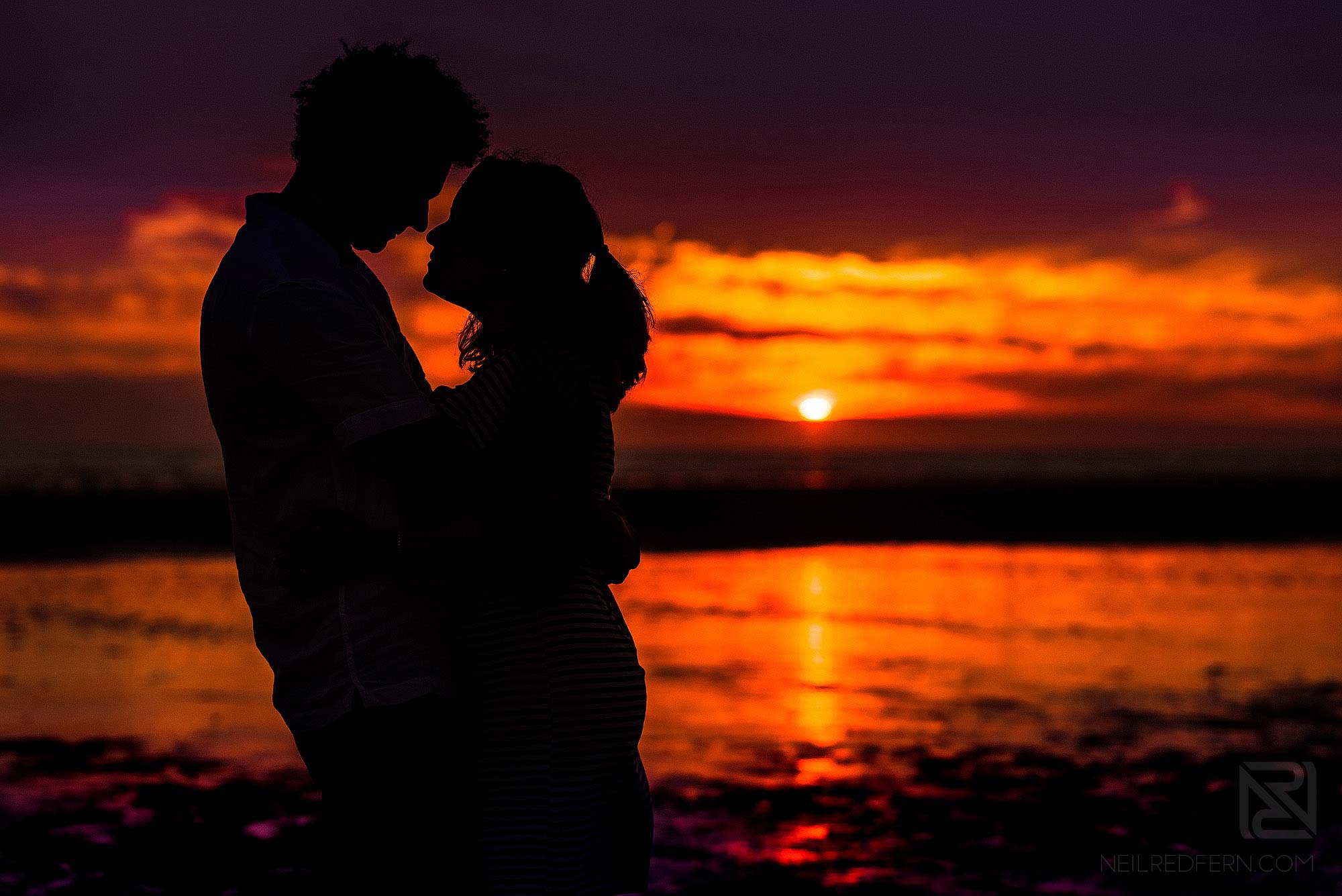 silhouette photograph of bride and groom on beach