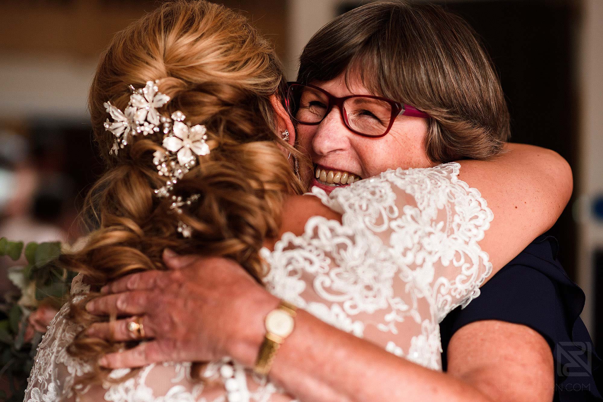 emotional hug between friend and bride