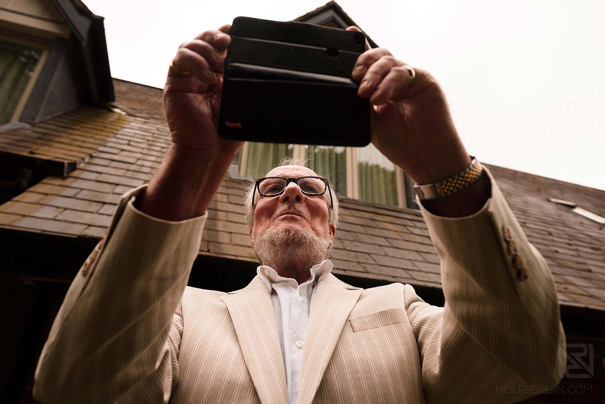 wedding guest taking photograph on phone