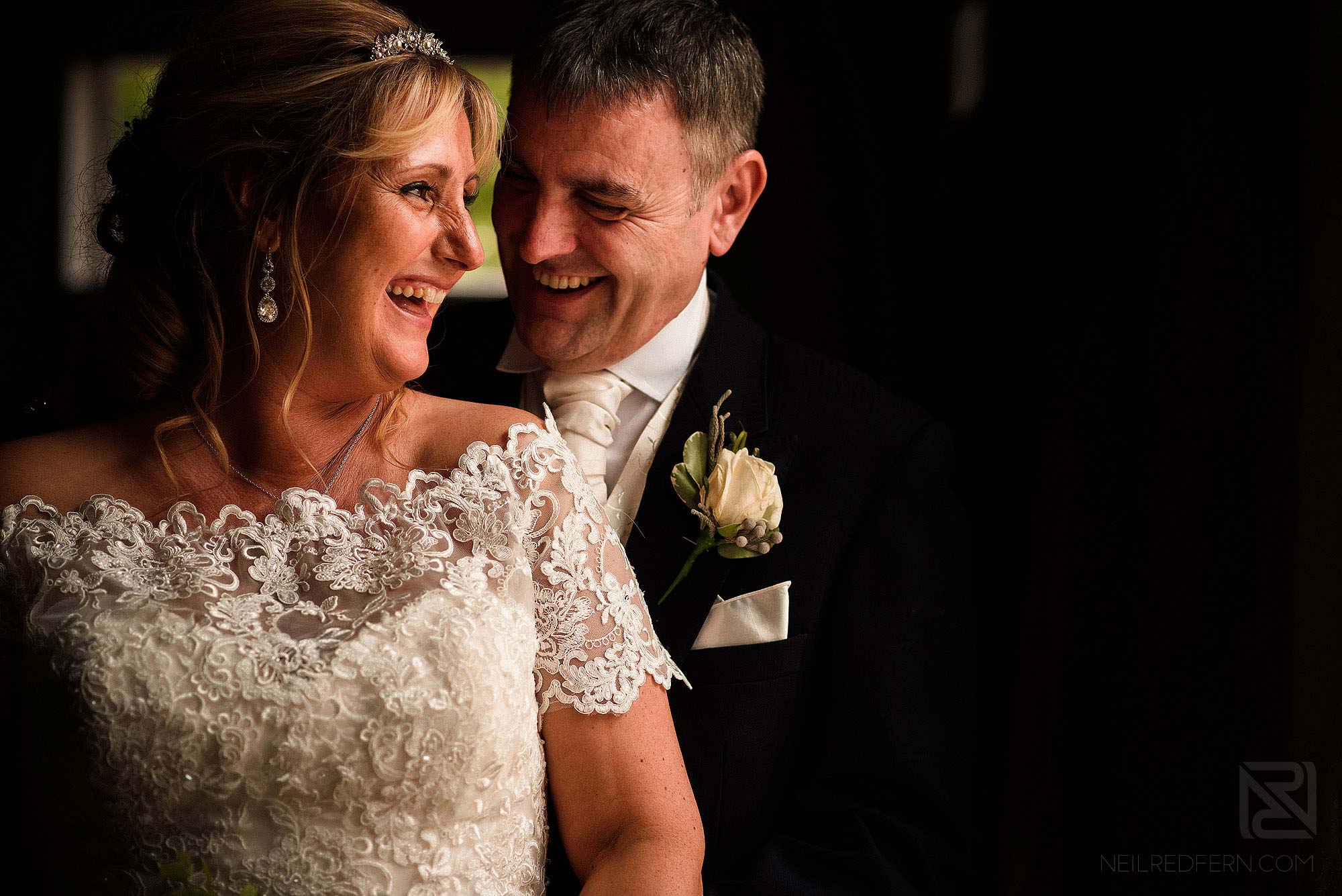 bride and groom laughing together