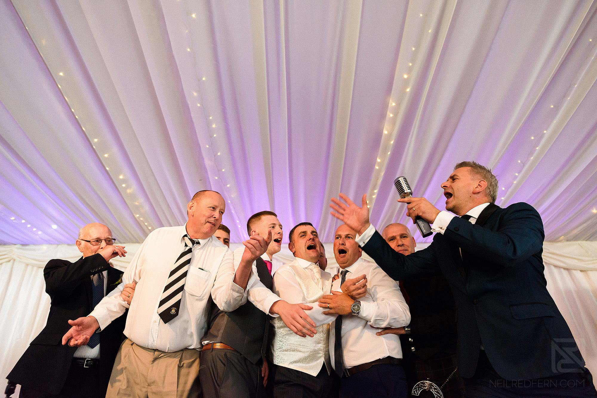 Paul Guard singing at wedding