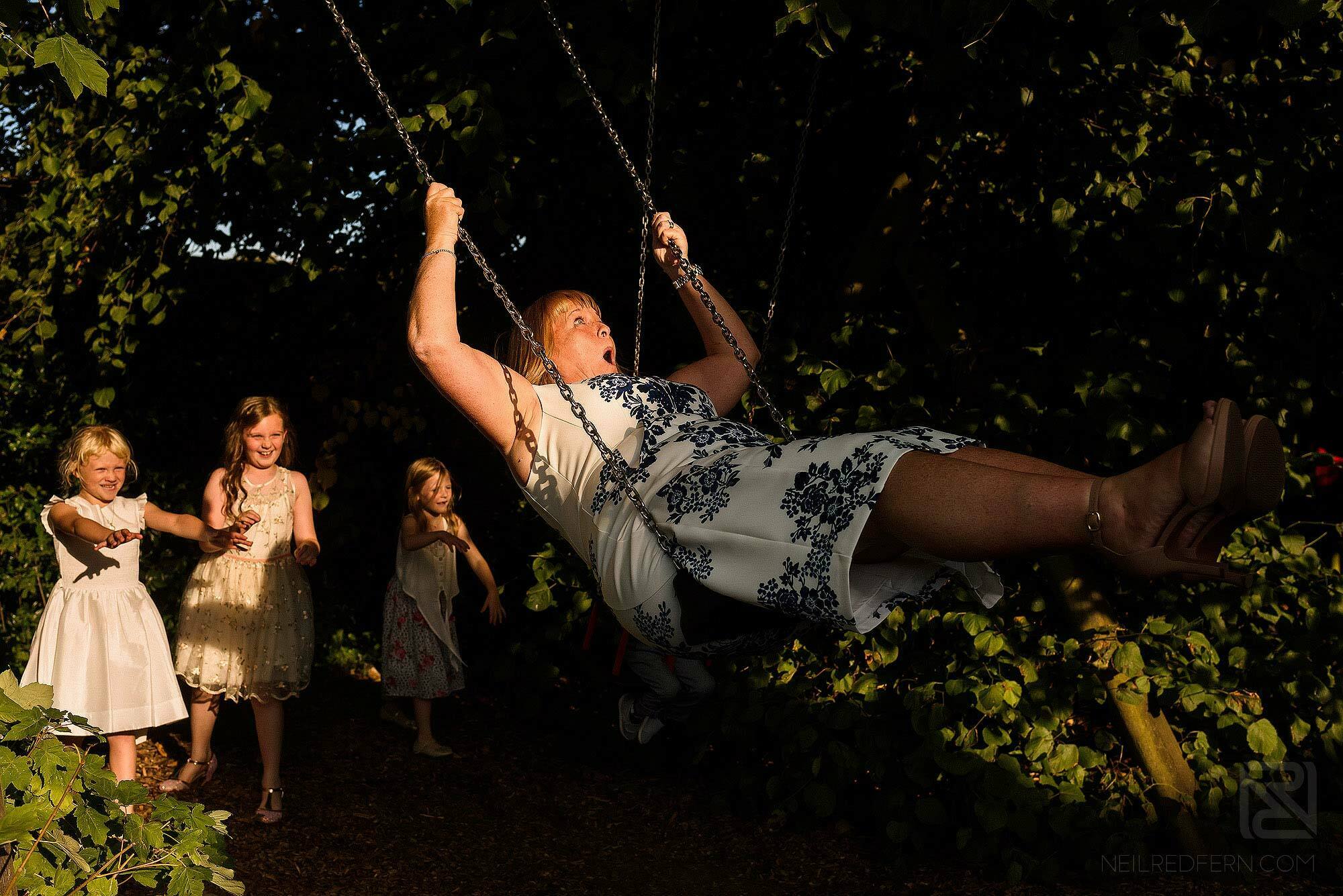 wedding guest on swing at The Villa Wrea Green in Lancashire