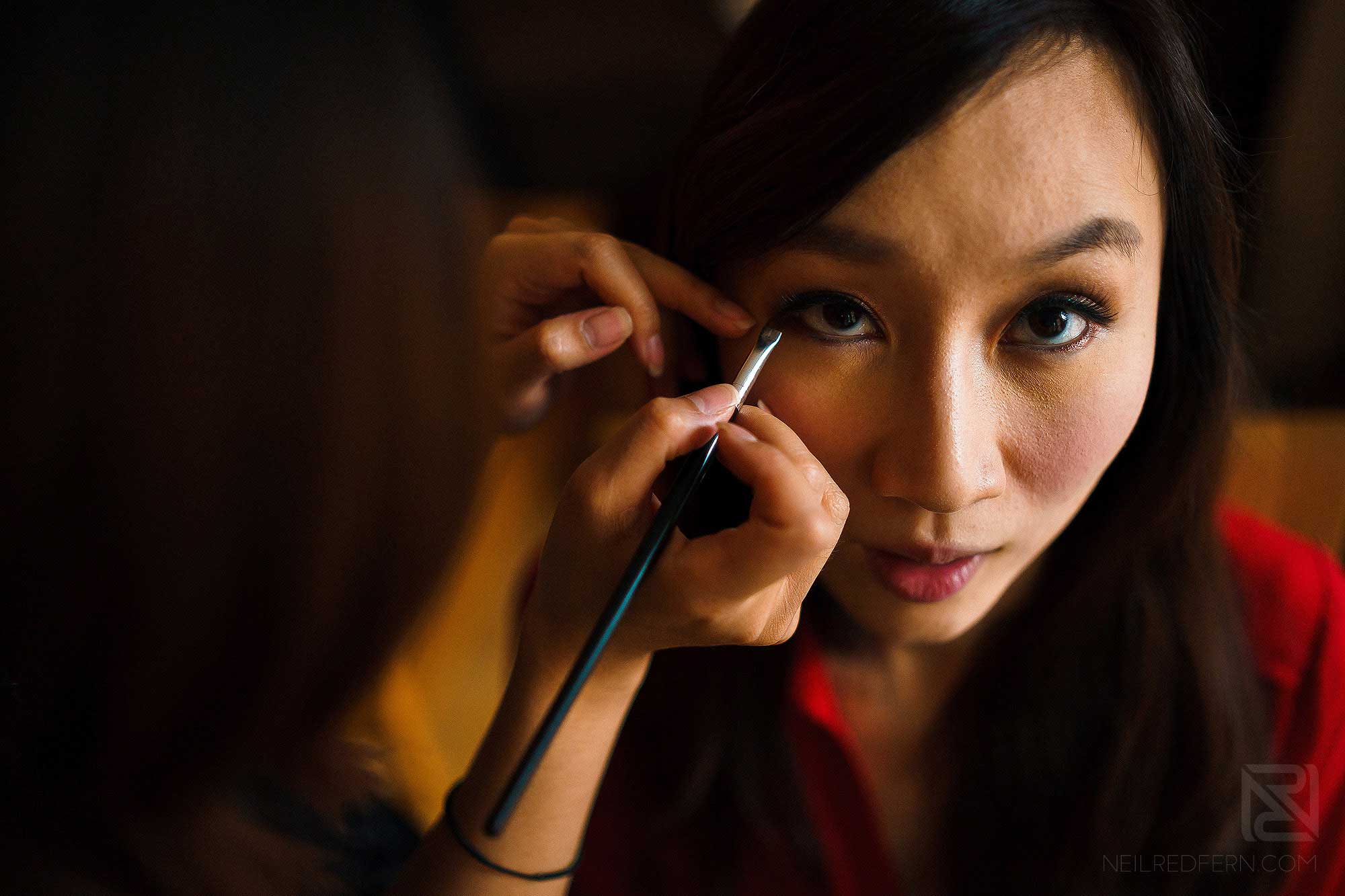 chinese bride having make-up put on