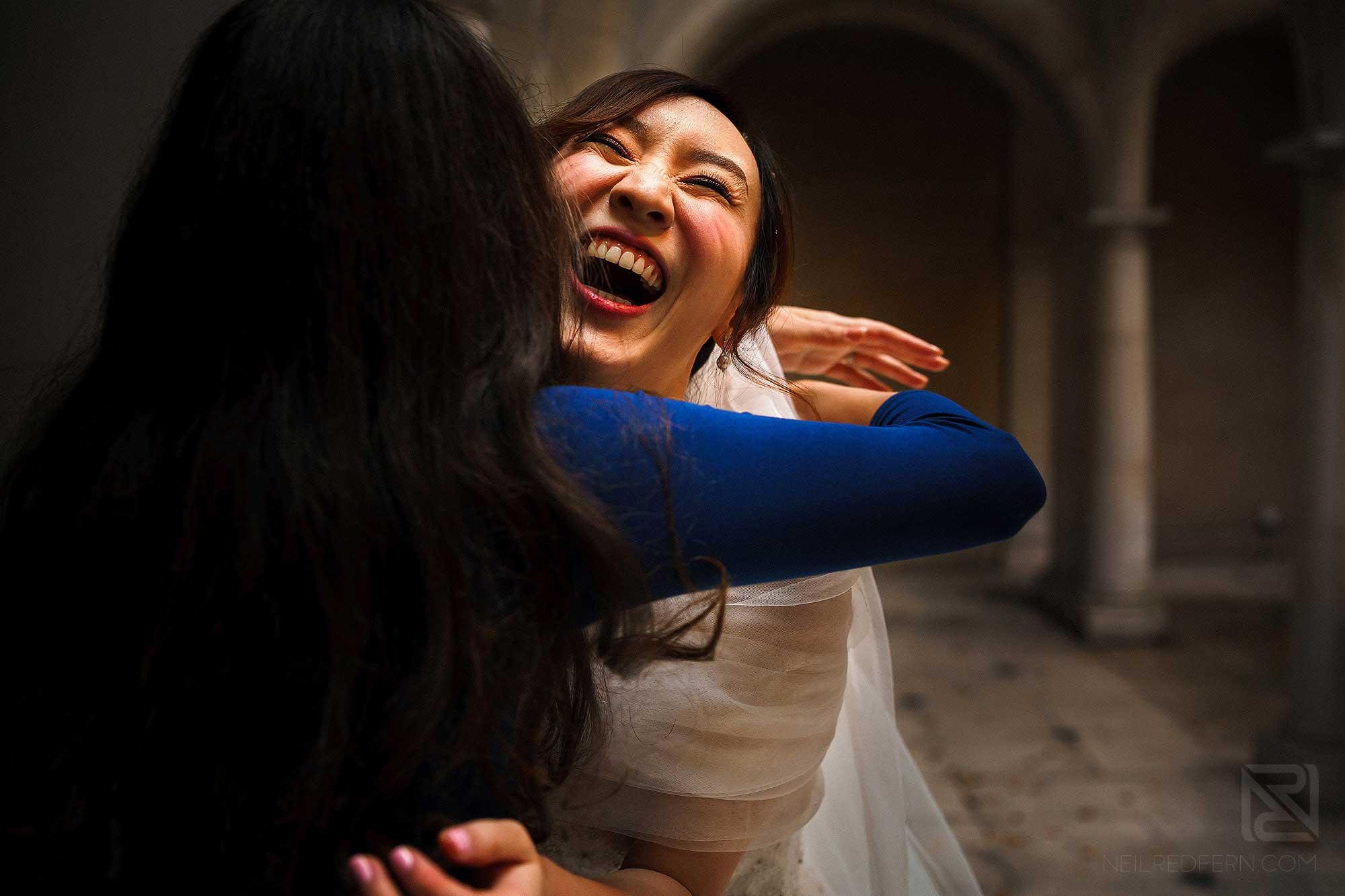 happy bride hugging friend