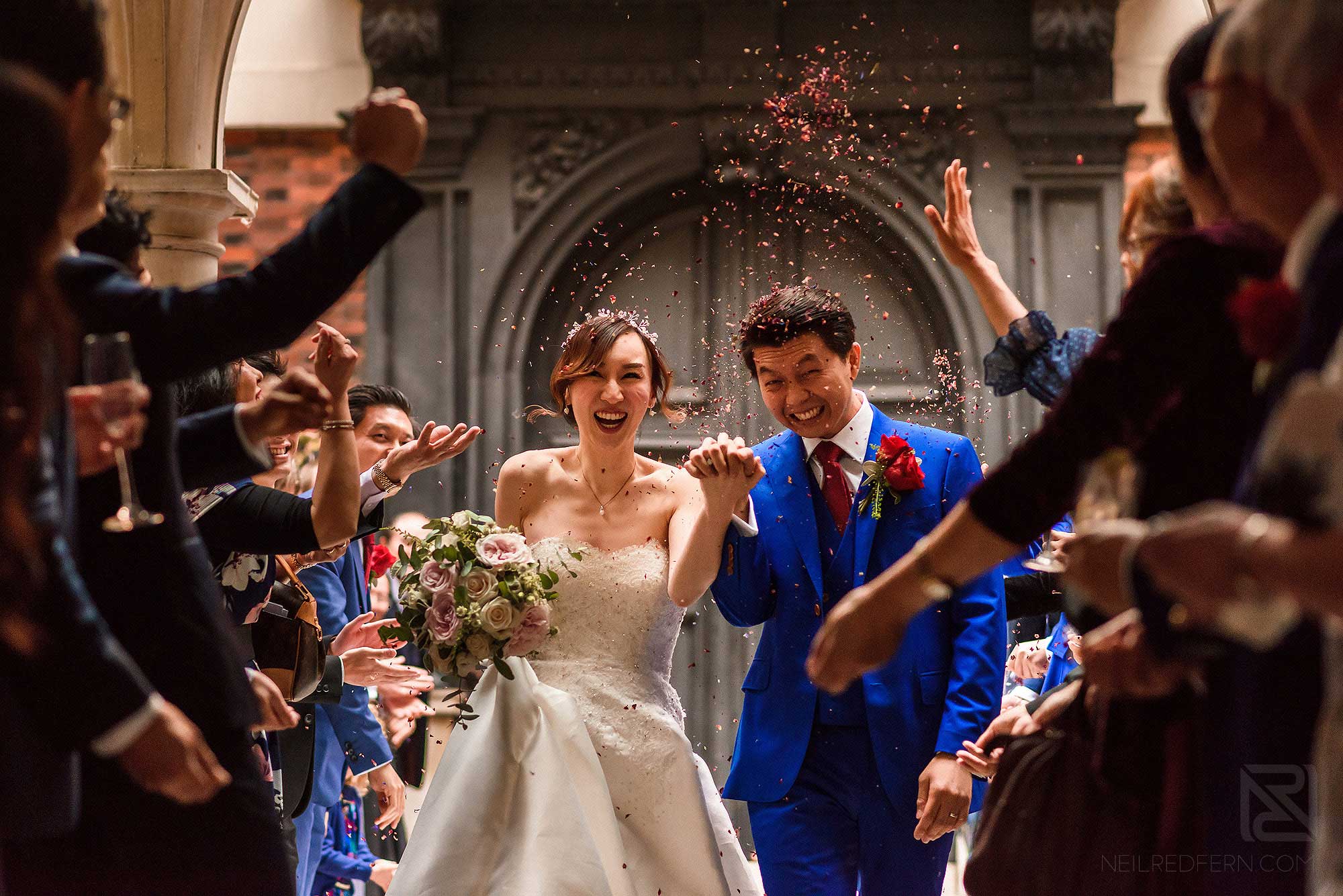 bride and groom walking through confetti