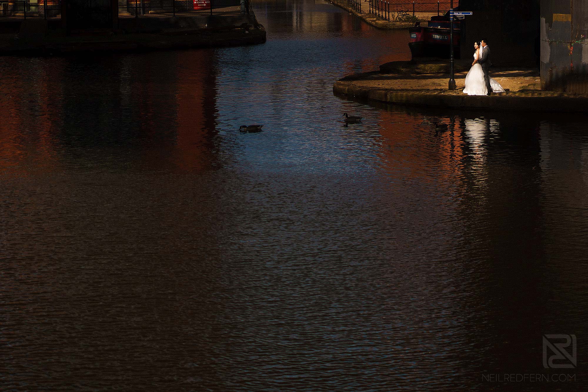 wide angle photograph of bride and groom in Castlefield in Manchester