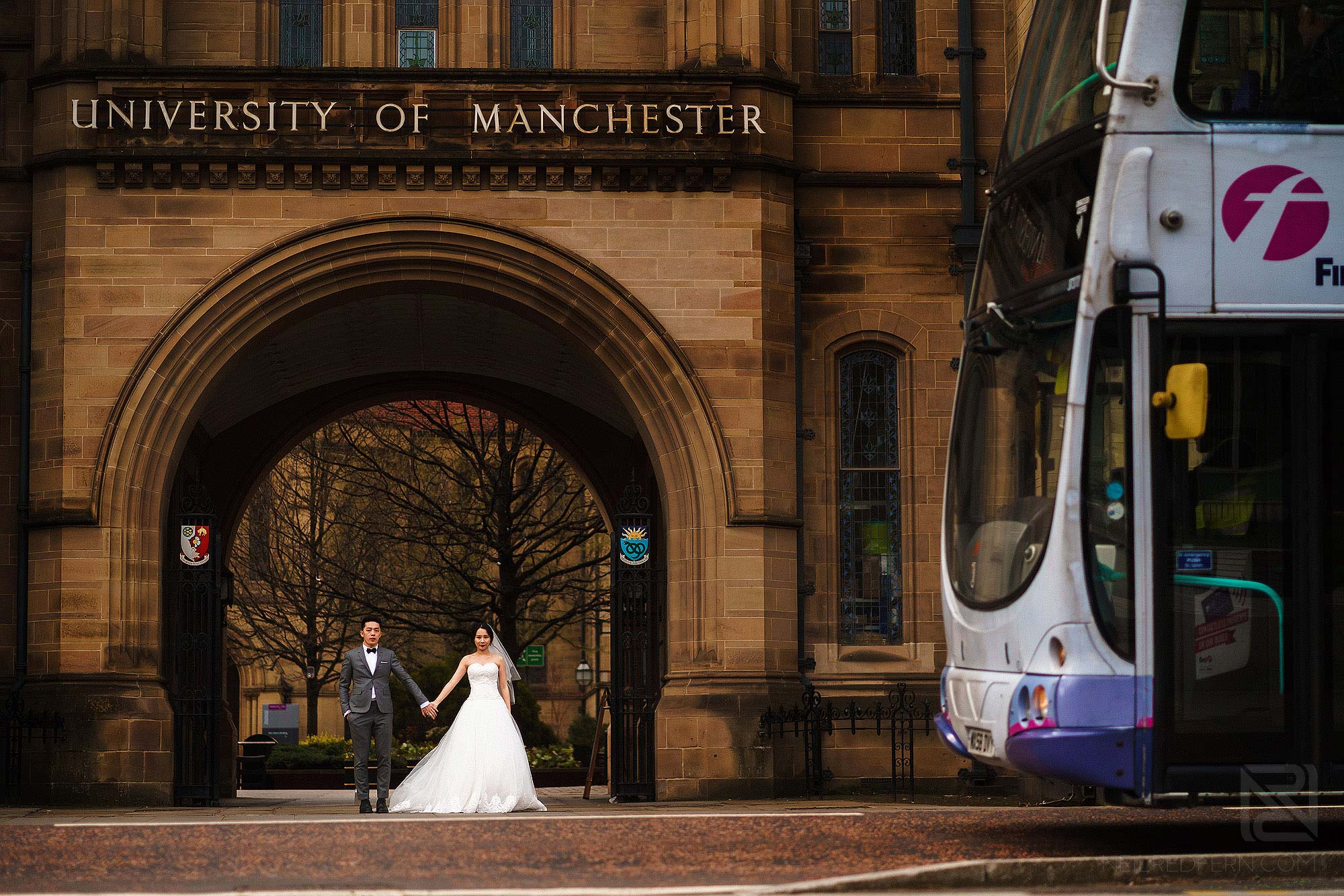 bride and groom outside University of Manchester