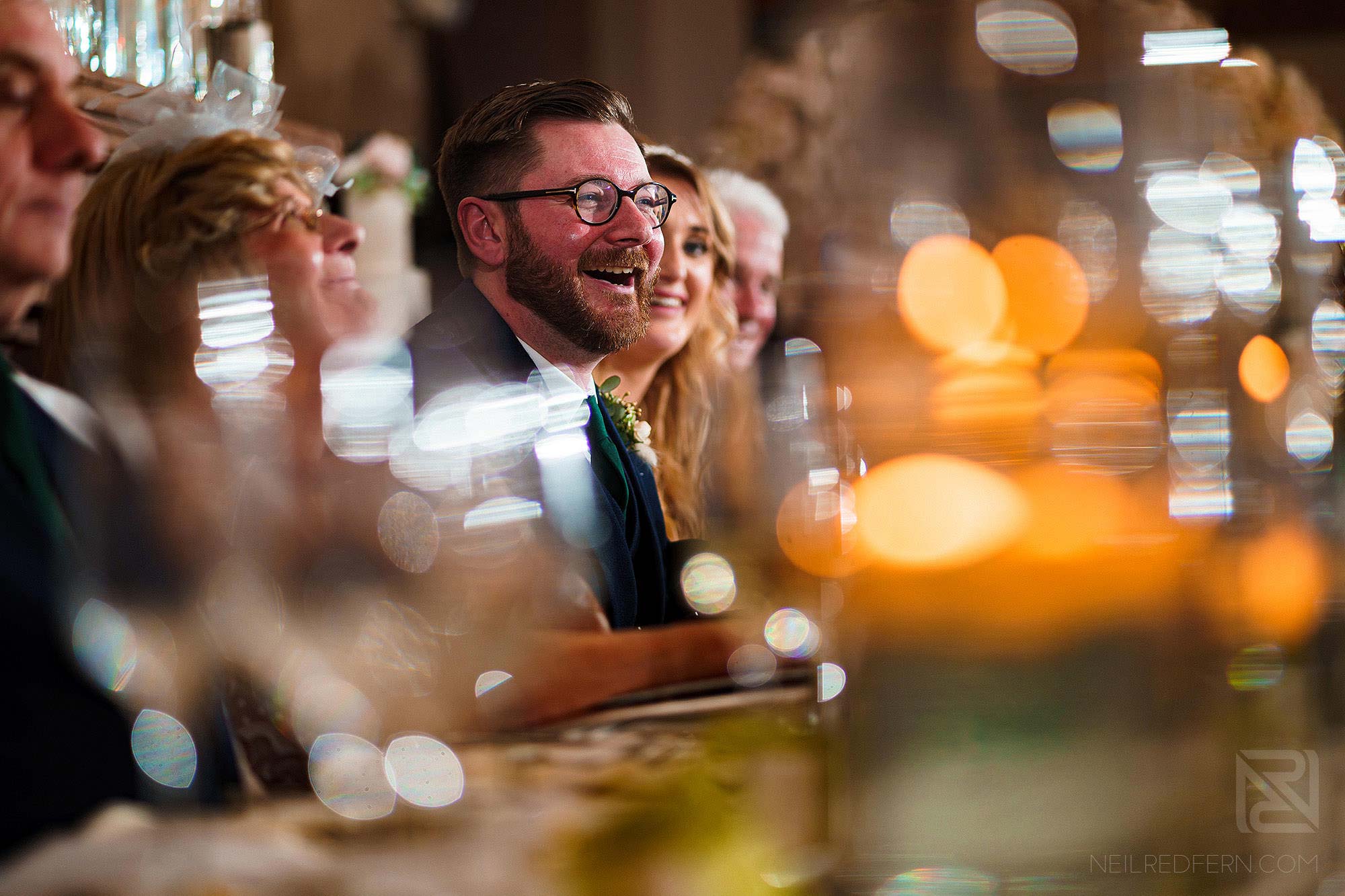 groom laughing during best man's wedding speech at Peckforton Castle